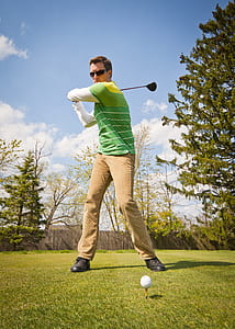 man playing golf outdoor during daytime thumbnail
