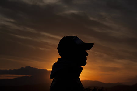 silhouette photo of person wearing cap thumbnail