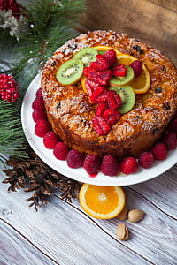 cake with kiwifruit, orange fruit, and berries on plate thumbnail