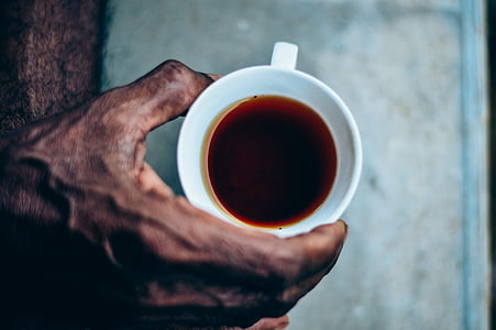 person holding cup of tea thumbnail