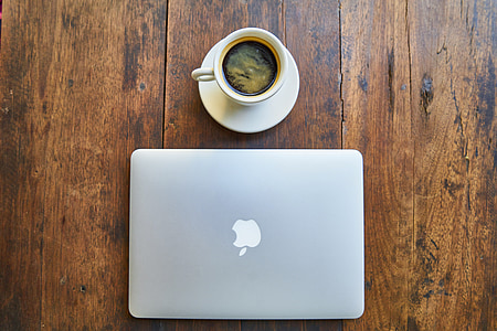 MacBook beside cup of coffee thumbnail