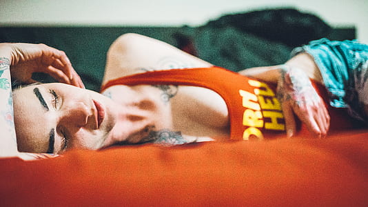 woman lying on orange cushion thumbnail