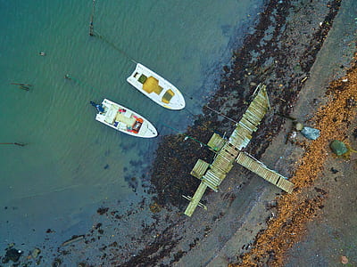 aerial photography of two white boats near dock at daytime thumbnail