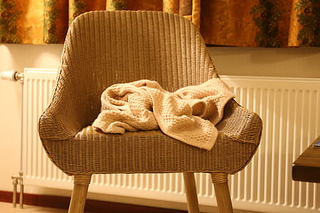beige towel on armchair thumbnail