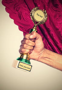 person holding trophy thumbnail