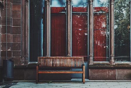 photo of brown wooden bench near glass window thumbnail