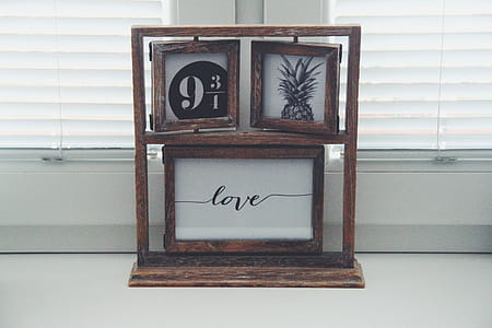 Brown Wooden Picture Frames Beside Window thumbnail