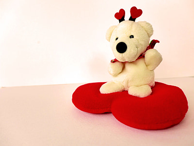beige bear plush toy on red heart pillow thumbnail