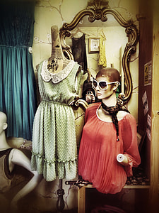 women's two red and green assorted outfits on dress forms near mirror thumbnail