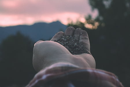 person with sands on his palm thumbnail