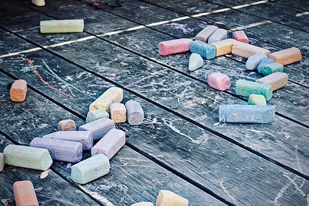 assorted-color chalk lot on black wooden board thumbnail