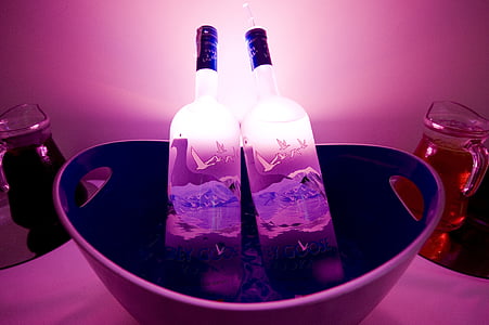 two glass bottles in white bucket thumbnail