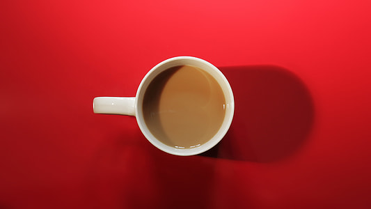 above angle photo of white ceramic mug with brown coffee in it thumbnail