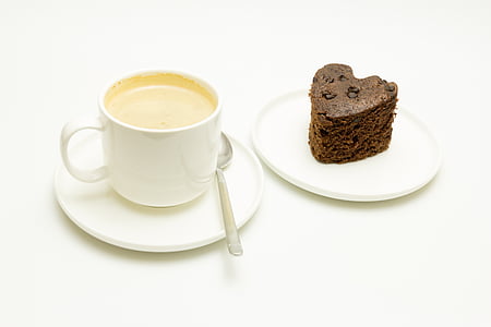 cup of coffee on saucer with teaspoon beside sliced cake thumbnail