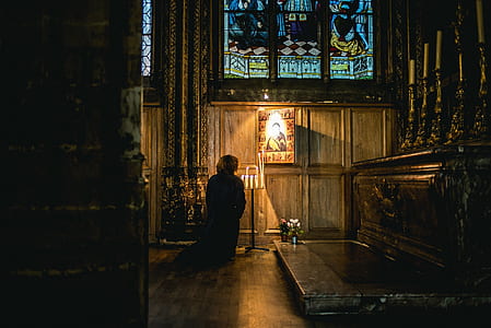 person kneeling inside cathedral thumbnail