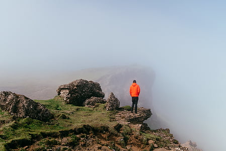 person standing on mountain top during daytime thumbnail