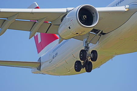 beige and red airliner going to land thumbnail