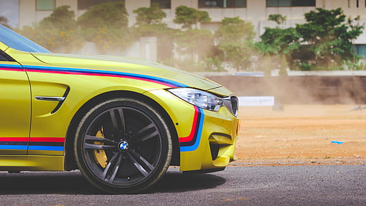 yellow BMW F30 on grey asphalt road during daytime thumbnail