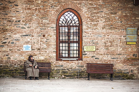woman sitting on bench near window thumbnail
