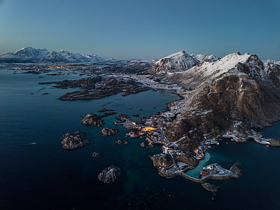 island with mountains near body of water thumbnail