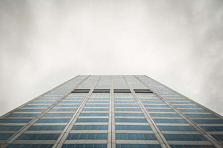 view of skyscraper from ground under cloudy sky during daytime thumbnail