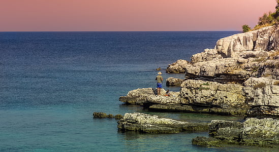 person standing near body of water thumbnail