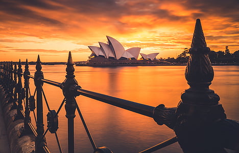 view of Sidney Opera House from across water during sunset thumbnail