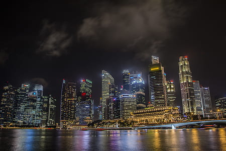 photo of buildings and body of water during nighttime thumbnail