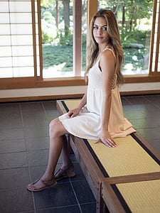 woman sitting on bench inside the room thumbnail