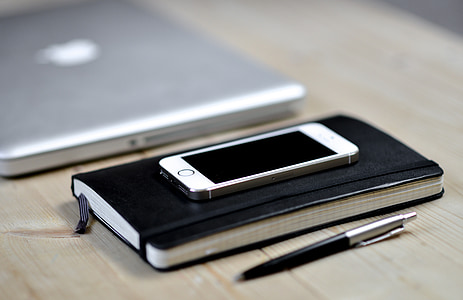 gold iPhone 5s on top black book binder thumbnail