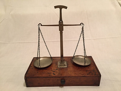 vintage balancing scale on white textile thumbnail