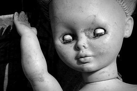 greyscale photo of doll thumbnail