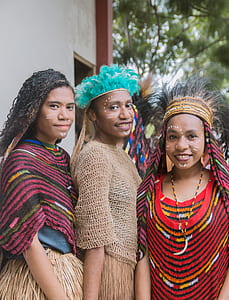 three smiling women with tribal costumes thumbnail
