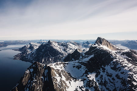 snow mountain beside body of water aerial photography at daytime thumbnail