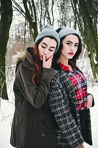 two woman wearing knit caps and coats under snowfield thumbnail