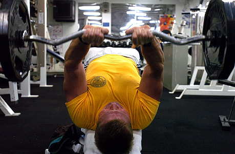 man in yellow crew-neck t-shirt lifting a barbel thumbnail