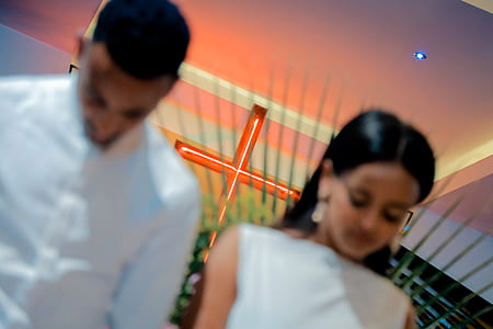 man and woman looking down while praying thumbnail