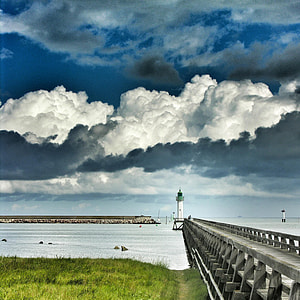 photo of gray concrete sea dock during cloudy day thumbnail