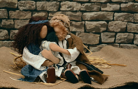 two dolls on brown area rug thumbnail