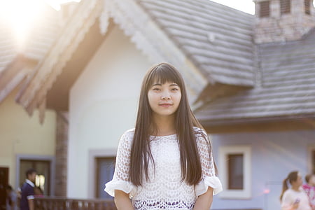 woman standing in front of white house thumbnail