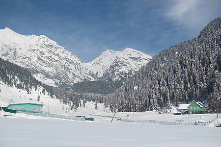 in distant snowconed mountain under blue sky thumbnail