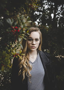 shallow focus photo of woman in black coat and v-neck shirt thumbnail