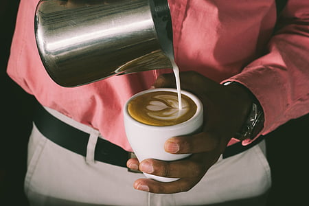 person pouring liquid on white ceramic cup thumbnail