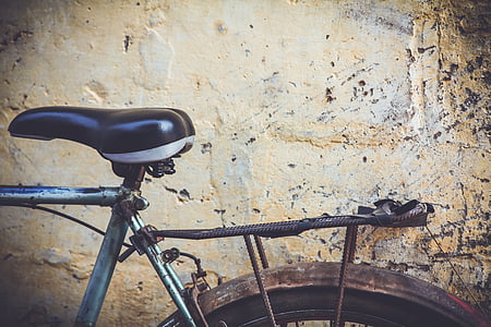 gray commuter bike parked near beige painted wall thumbnail