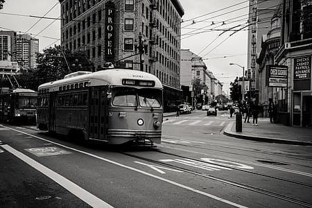 Grayscale Photography of Tram Near Buildings thumbnail