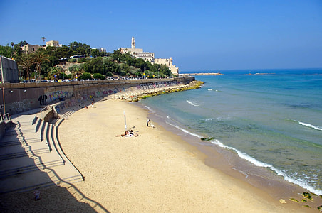 person sitting at coastline facing body of water thumbnail