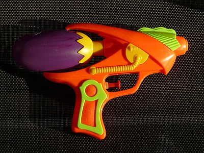 orange, green, and purple toy gun on black surface thumbnail