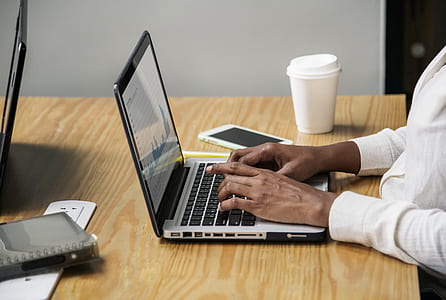 man working in front of silver laptop computer on table thumbnail