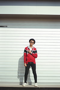 Man In Red And Black Zip-up Jacket And Black Pants With Black Hat thumbnail