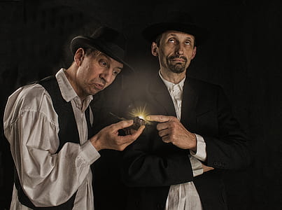 man holding smoking pipe standing beside man thumbnail